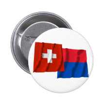 Wellenartig bewegende Flaggen der Schweiz u. Tessi Anstecknadelbutton
