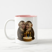 2 sweet Capuchin monkeys lovingly embrace + cake