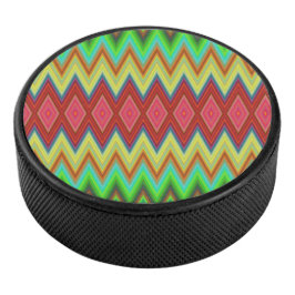 A circular speaker with a vibrant, zigzag pattern eishockey puck
