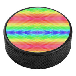 A hockey puck with a vibrant, symmetrical rainbow 