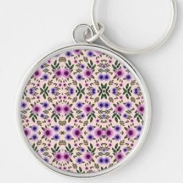 A round keychain features a detailed floral  schlüsselanhänger
