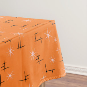 Abstrakte Linien und rosa Sterne auf orange Retro Tischdecke