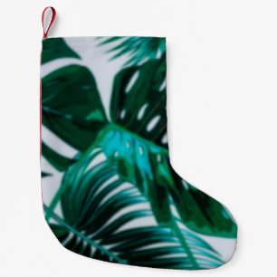 Abstrakter Hintergrund der grünen Plantage abgrenz Kleiner Weihnachtsstrumpf