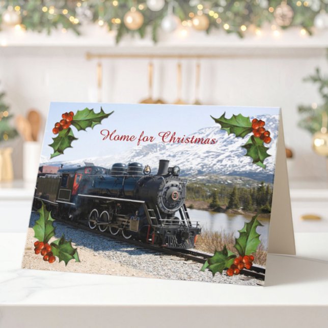 Accueil sur la carte Train for Christmas (A folded Christmas card of an old steam train, snowy mountains and corner decorations of holly.)