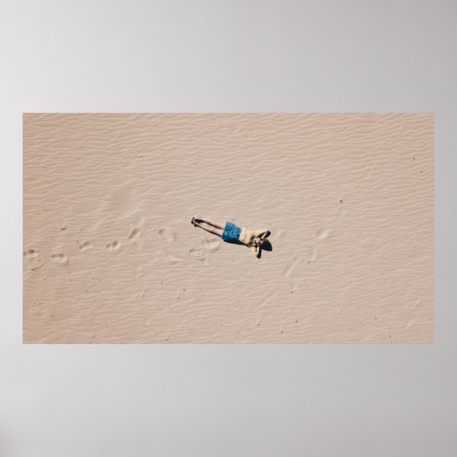 Aerial photograph of man lying on sand poster (Vorne)