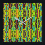 Afrocentric Geometric Cowrie Shells  Quadratische Wanduhr<br><div class="desc">Bring cultural artistry and modern geometry together with this Afrocentric Geometric Cowrie Shells Square Wall Clock. Designed in an earthy blend of green, orange, blue, burgundy and black, the motif highlights the symbolic beauty of cowrie shells while introducing a structured, contemporary pattern. The result is a striking wall accent that...</div>