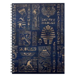 Ägyptische Hieroglyphen und Gottheitgold auf Notizblock
