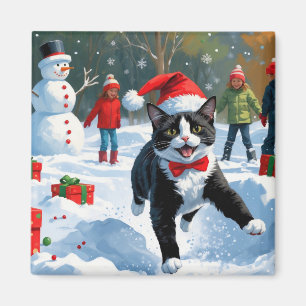 Aimant Chat Tuxedo Courant dans la Neige avec un Chapeau