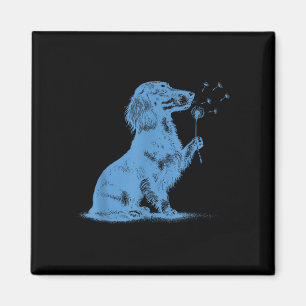 Aimant Dachshund soufflant des vœux sur un pissenlit amou