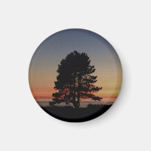 Aimant rond avec coucher de soleil de silhouette d
