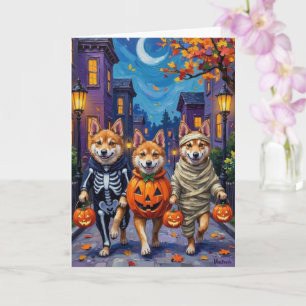 Akita-Hunde beim Trick-or-Treat in Halloween-Kostü Karte