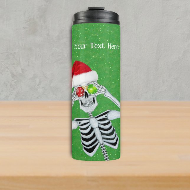 Albernes Weihnachtsgeschmack Eyes Green Gold Thermosbecher (Funny Christmas skeleton Santa Hat Ornament eyes on green with gold specks thermal drink tumbler.)