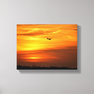 Alleinstehendes Flugzeug bei Sonnenuntergang Leinwanddruck