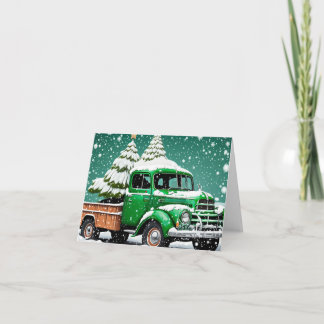 Alter grüner LKW mit Christbaum hinten.