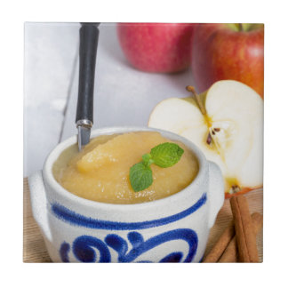 Applesauce with cinnamon in stoneware bowl fliese
