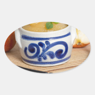 Applesauce with cinnamon in stoneware bowl ovaler aufkleber