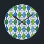 Art Deco Rain Argyle Runde Wanduhr<br><div class="desc">This wall clock has an art deco design of diamond shapes made from overlapping angles in black lines colored in shades of blue and green with diagonal black lines making the design look like argyle</div>