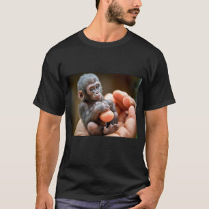 "Baby Monkey Sitting Holding Food in Hand T-Shirt" T-Shirt