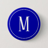 Blanc de monogramme sur le bouton rond de bleu