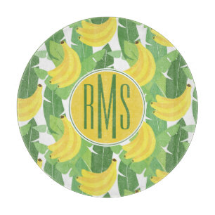 Bananen-Blätter und Monogramm des Frucht-Muster- Schneidebrett
