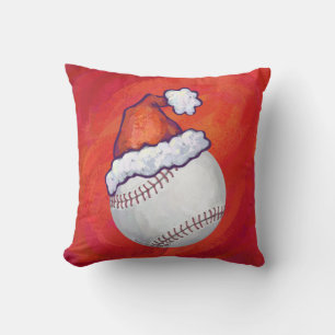 Baseball mit Weihnachtsmannmütze auf Rot Kissen