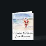 Beach Santa Watercolor Weihnachtskarte Feiertagskarte<br><div class="desc">Diese Weihnachtskarte zeigt einen entspannten Weihnachtsmann,  der einen langen Spaziergang am Strand genießt. Passen Sie diese Weihnachtskarte an,  um Ihre Lieblingsstadt am Strand zu reflektieren!</div>