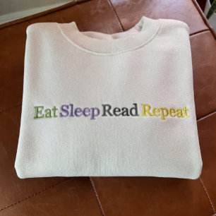 Besticktes Shirt 'Eat Sleep Read Repeat'