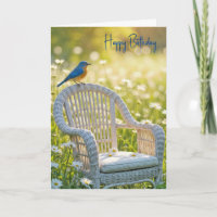 Birthday Bluebird auf einem Wicker-Stuhl