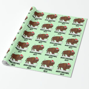 Bison in einer Weihnachtsmannmütze am Geschenkpapier