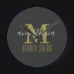 Black Beauty Salon by Anastasia Monogram Runde Wanduhr<br><div class="desc">Black Beauty Salon by Anastasia Monogram Round Clock. Gold monogram letter with name of business and owner on black background. Customize it with your own information.  @Miri Creations - Created For You Only with You In Mind!
 Copyright Miri Creations,  all rights reserved.</div>