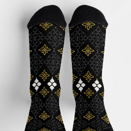 Black socks featuring a gold and white pattern  socken