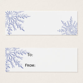 Blaue Winterschneeflocken auf weißen Geschenketike