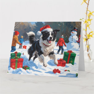 Border Collie mit Santa-Hut spielt im Schnee Karte
