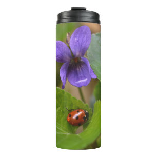 Bouteilles Isothermes Ladybug sur les fleurs de violet doux