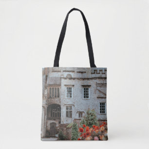 BRAUNES ZIEGELHAUS NAHE ROTER BLUMEN TASCHE