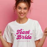 Bridesmaid Pink Team Bride Bachelorette T-Shirt<br><div class="desc">Der Bridesmaid Pink Team Bride Bachelorette T - Shirt ist eine unterhaltsame und Retro-inspiriert Ergänzung zum Kleiderschrank Ihrer Brautmeisterin. Dieses Shirt mit einem spielerisch rosa Schriftart mit "Teambride" in fett geschriebenem Text kann mit dem Namen jeder Brautjungfrau abgestimmt werden und ist somit das perfekte Hochzeitsgeschenk. Ideal für Bachelorette-Festlichkeiten, fügt es...</div>