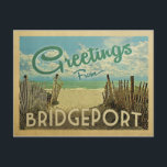 Bridgeport Beach Vintage Travel Postkarte<br><div class="desc">Diese Grüße aus Bridgeport Vintage Postkartendesign besticht durch einen Sandstrand mit türkisblauem Meerwasser und einen blauen Himmel mit duftigen weißen Wolken. Im Vintage Reisen Stil.</div>