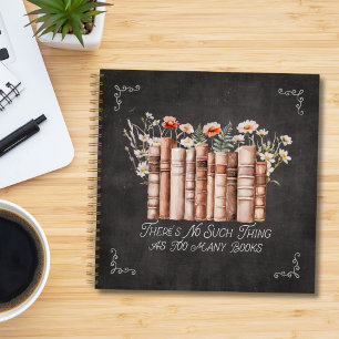 Bücher mit Blumen und Zitat auf schwarzem Notizbuc