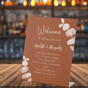 Burnt orange eucalyptus wedding program timeline sockelschild