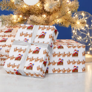 Cadeau Père Noël sur papier d'emballage de Noël de traîne