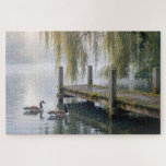 Canada Geese on a Misty Lake with a Dock<br><div class="desc">A tranquil lake features a rustic wooden dock beneath elegant willow branches in the mist,  while two Canada geese glide across the still water,  creating gentle ripples behind them</div>