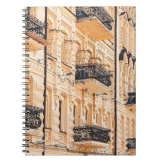 Carnet Une vieille maison jaune aux balcons en fer forgé.