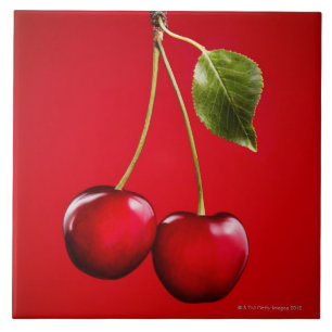 Carreau Cerises avec la feuille sur l'arrière - plan rouge
