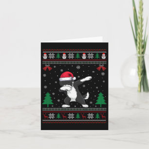 Carte Bernedoodle qui dabe sous un chapeau de Père Noël 