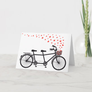 Carte bicyclette en tandem avec des cœurs rouges