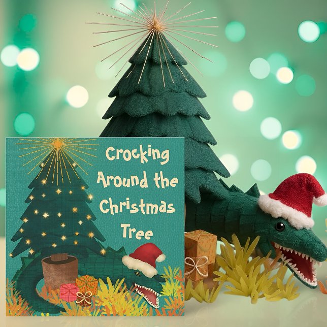 Carte Croquer autour de Noël (Funny Christmas card with a crocodile in a Santa hat under a tree and the pun Crocking Around)