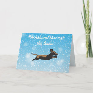Carte Dachshund à travers les cadeaux de Noël