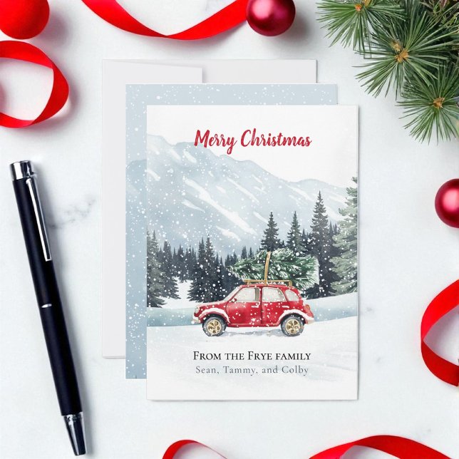 Carte de vacances Red Car Christmas Tree Mountain (Christmas holiday red car with Christmas tree on a snowy mountain top. Card is on marble countertop)