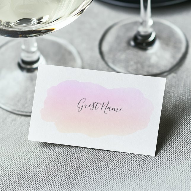 Carte du nom de l'invité de l'aquarelle rose doux (Soft watercolor pink paint wash on a white guest name place card at a wedding dining table)
