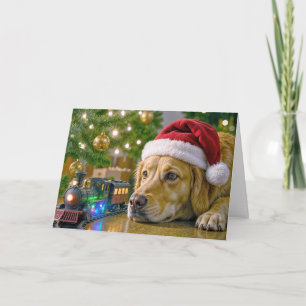 Carte Golden Retriever de Noël regardant un train jouet